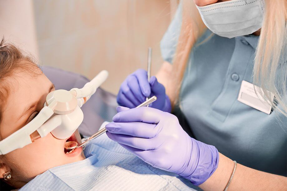 Child with sedation getting dentist treatment