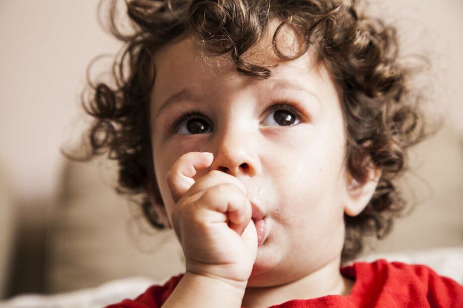 child sucking his thumb